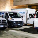 Force1 restoration service vehicles parked outside building.